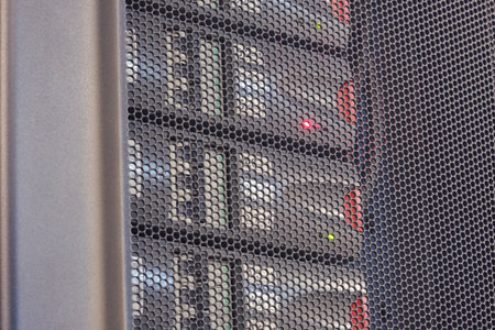 The UPS module in the server room is emitting a red light warning signifying an error with the battery.の写真素材