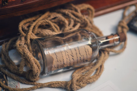 Vintage glass bottle with a note inside about a shipwreck. Old objects of the 18th century era, reenactment of eventsの写真素材