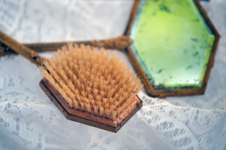 Women's mirror and hair comb made of brass, boar hair and glass. Old objects of the 18th century...