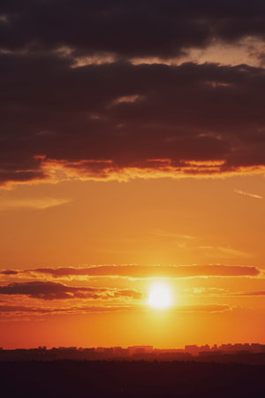 The setting sun created a stunning display of fiery orange and red colors in the evening sky as it...