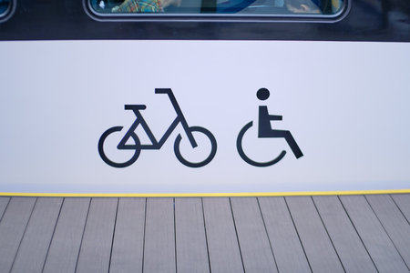 Bicycle and wheelchair sign on the platform of a train station, closeup of photo