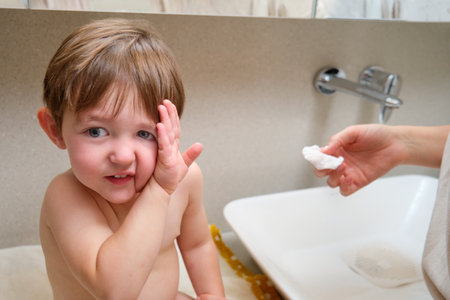 The child refuses to wash by closing his hand. Kid aged two years (two-year-old boy) Baby doesn't want to wash in the bathroomの写真素材
