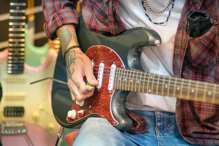 Man playing the electric guitar in a music store. Close-up - Moscow, Russia, September 20, 2023のeditorial素材