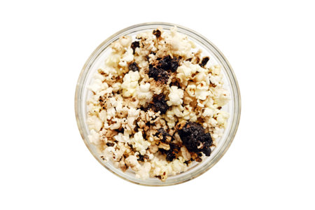 Burnt popcorn from a home microwave. Burn corn kernels on the kitchen table, isolated on white backgroundの写真素材