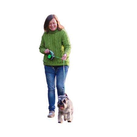 Happy adult woman walking with her dogs in the park, isolated on white background. Selective focusの写真素材