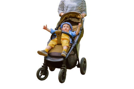 Mother with a baby boy in a pram is enjoying the sunny weather at the park, isolated on white background. Kid aged about two years (one year eleven months)の写真素材