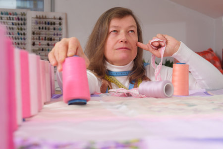 Female fashion designer working on new collection of clothes in her studio.