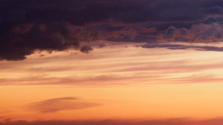 The blue and purple hues of the evening sky were reflected in the clouds, creating a dreamy and...
