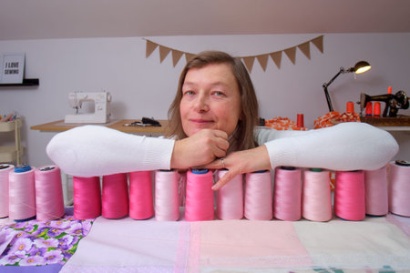 Portrait of a middle-aged woman in a sewing workshop.