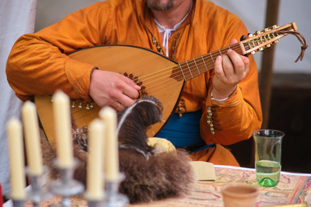 A man plays an oud lute, hands on strings in close-upの写真素材