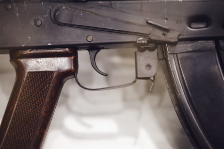 Close-up of firearm trigger and grip with magazine. Detailed view.