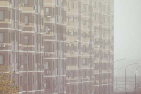 Windows on the facades of high-rise apartment buildings, smoke close-up