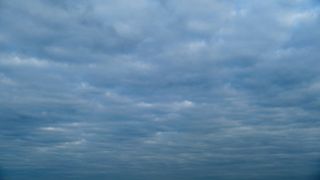 Overcast sky with layered stratocumulus clouds. Natural cloudy sky background. Weather and atmosphere conceptの写真素材