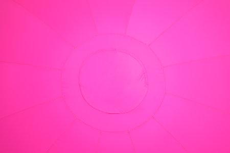 Bright pink tent interior with circular pattern. Abstract colorful vibrant fabric background. Textile texture design.の写真素材