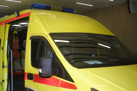 Yellow ambulance car with blue light. Emergency medical service vehicle ready for critical care and rescue operation. Healthcare and urgent aid concept.の写真素材