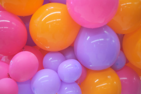 Bright multicolored balloons forming a festive background. Colorful party decoration wallpaper for...