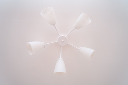 Modern white ceiling light with six lamps. Minimalist design for home decor. Contemporary interior illumination fixture.の写真素材