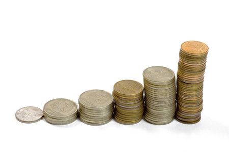 Raising stack of coins. Concept of  a growing chart. Isolated on white