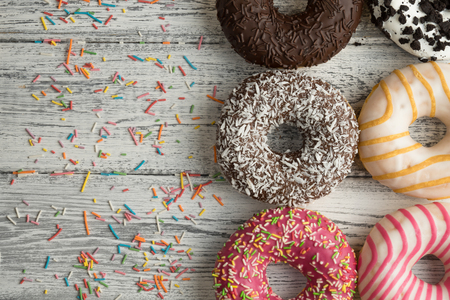 A donut with icing on white wooden background.の写真素材