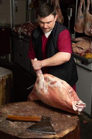 The chopping the meat, professional work of the butcherの写真素材