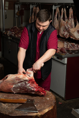 The chopping the meat, professional work of the butcherの写真素材