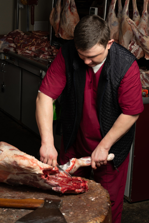 The chopping the meat, professional work of the butcherの写真素材
