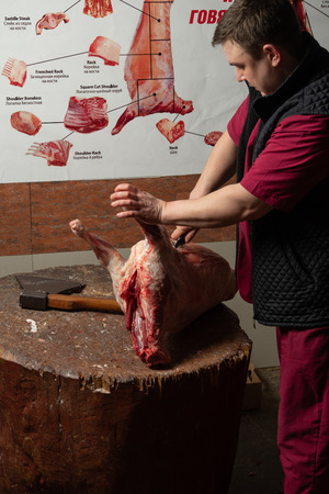The chopping the meat, professional work of the butcherの写真素材