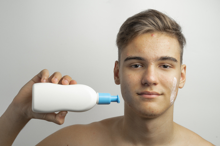 a teenager uses a remedy of acne and blackheads on the faceの写真素材