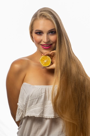A Girl with long hair and pomegranateの写真素材