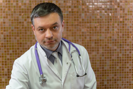A mature doctor posing and at camera, healthcare and medicineの写真素材