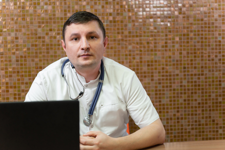 Doctor working with laptop in a hospitalの写真素材