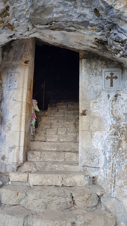 Entrance to the ancient cave in the mountainsの写真素材