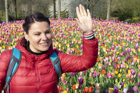 Girl in the flower Park welcomes friendsの写真素材