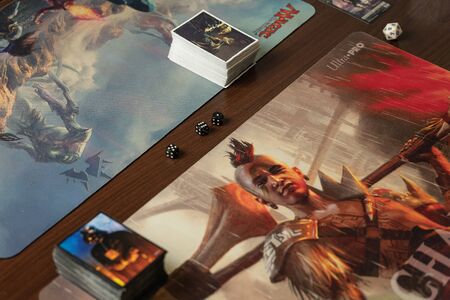 SOCHI, RUSSIA-MAY 17, 2019: Two game sets Magic The Gathering with cards and dice which lie on the game tableのeditorial素材