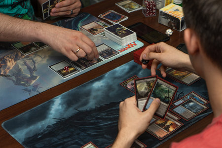 SOCHI, RUSSIA-MAY 17, 2019: Two guys are playing on new expansion game The War of the Spark Magic...