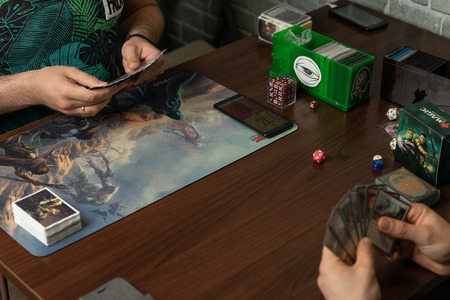 SOCHI, RUSSIA-MAY 17, 2019: Two boys are playing the new expansion game The War of the Spark Magic The Gatheringのeditorial素材