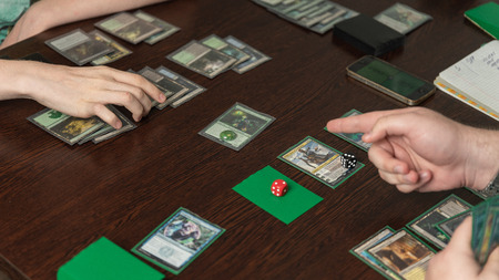SOCHI, RUSSIA-MAY 17, 2019: Two teenagers are playing in board game Magic The Gathering in the board games clubのeditorial素材