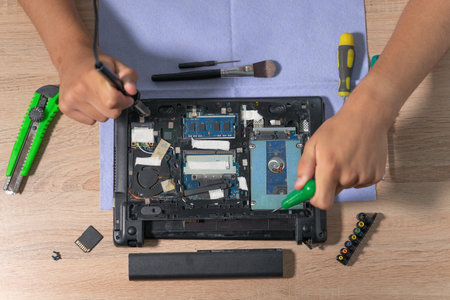 Engineer fixing broken computer at work. Electronic repair shop. Computer maintenance