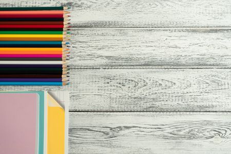 Stationery pencils, school notebook on wooden background. Copy space. Flat lay. Top view. Concept Educationの写真素材