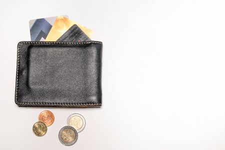 Leather wallet, with Euro coins and credit or debit cards, on a white backgroundの写真素材
