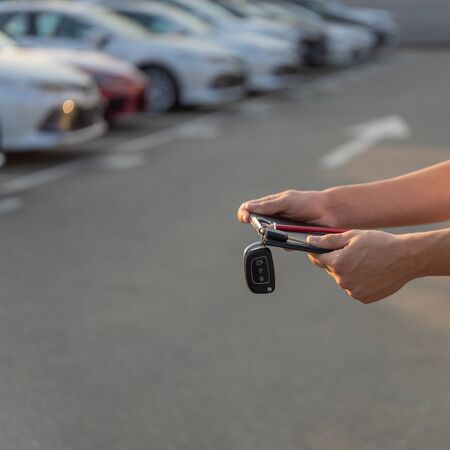 Car keys in the hands of a car dealer. Selective focus on a key from vehiclesの写真素材