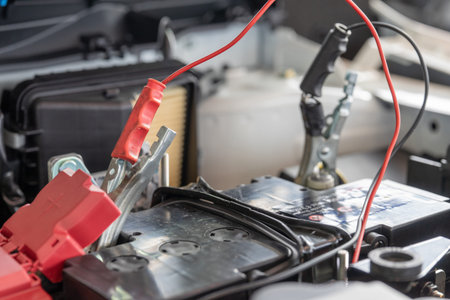 Charging car battery with electricity through jumper cables.の写真素材