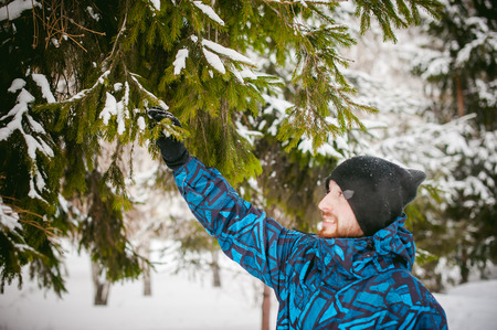 men walk in a winter park. guy with good humor and smile, warm clothing walking outdoorsの写真素材