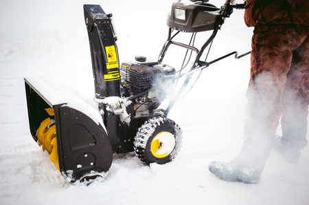 man starts the engine snow blowerの写真素材