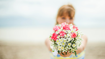 woman holding a bridal bouquet. bridesmaid took wedding flowersの写真素材