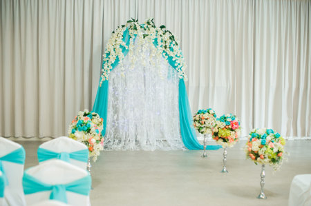 decorated festive wedding hall. a wedding arch for the wedding ceremony when the bride and groom. elegant chairs for guestsの写真素材