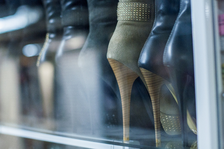 showcase in the store with women's shoes, heels in a rowの写真素材
