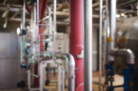 Beer manufacture line. Equipment for staged production bottling of Finished food products. Metal structures, pipes and tanks at enterprise factory. Special equipment inside within industrial premisesの写真素材