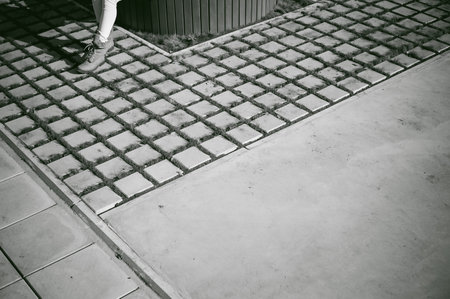 Portrait of young woman walking outdoors on warm autumn afternoon. Sitting restingの写真素材