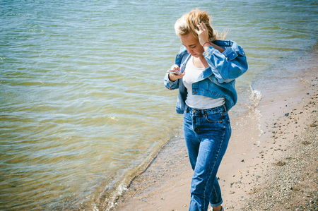 young beautiful woman in jeans clothes outdoorsの写真素材